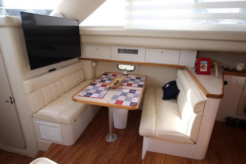 Slide: The Image of 1997 Cruisers Yachts 3650 Motoryacht interior with dining area and TV. - 23