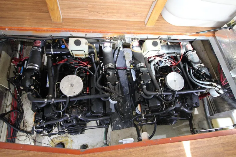 Slide: The Image of Engine room of a 1997 Cruisers Yachts 3650 Motoryacht, showcasing dual engines and wiring. - 33