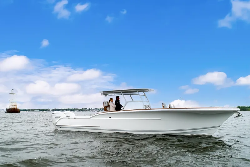 The Image of 2019 Buddy Davis 34 Center Console boat on open water under blue sky. - 1