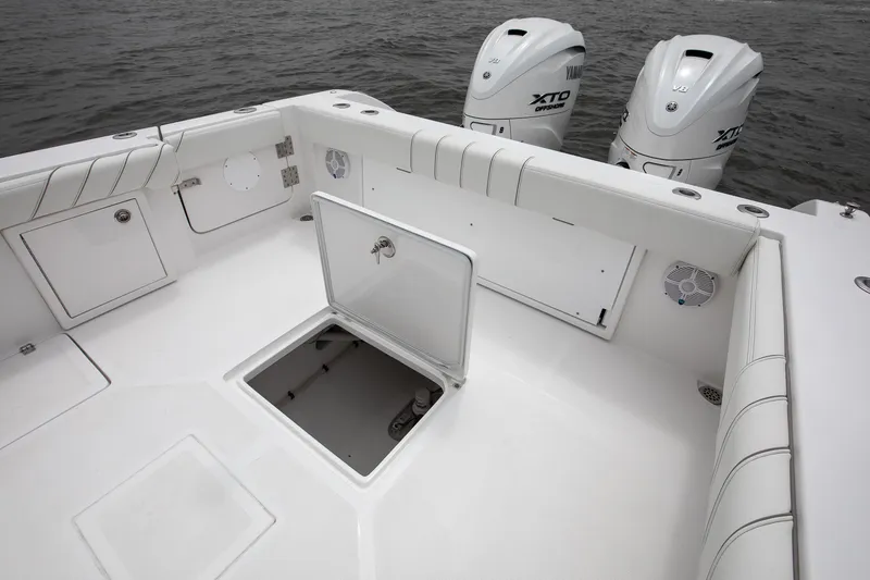 Slide: The Image of 2019 Buddy Davis 34 Center Console boat with open hatch and twin Yamaha outboard engines. - 3