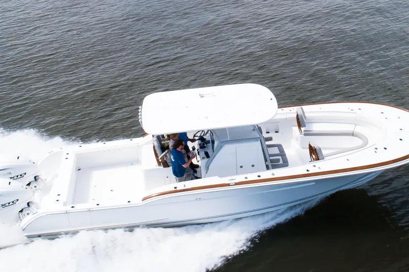 Slide: The Image of 2019 Buddy Davis 34 Center Console boat cruising on open water. - 4