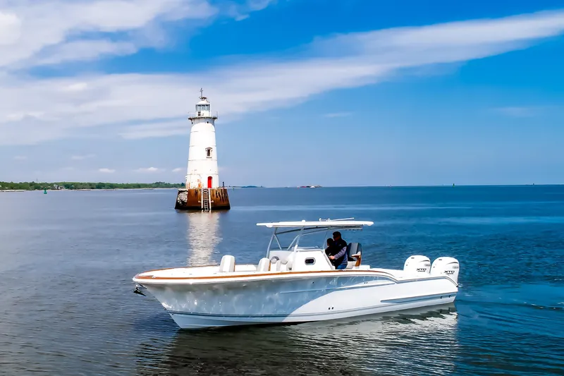 Slide: The Image of 2019 Buddy Davis 34 Center Console boat near a lighthouse on calm waters. - 5