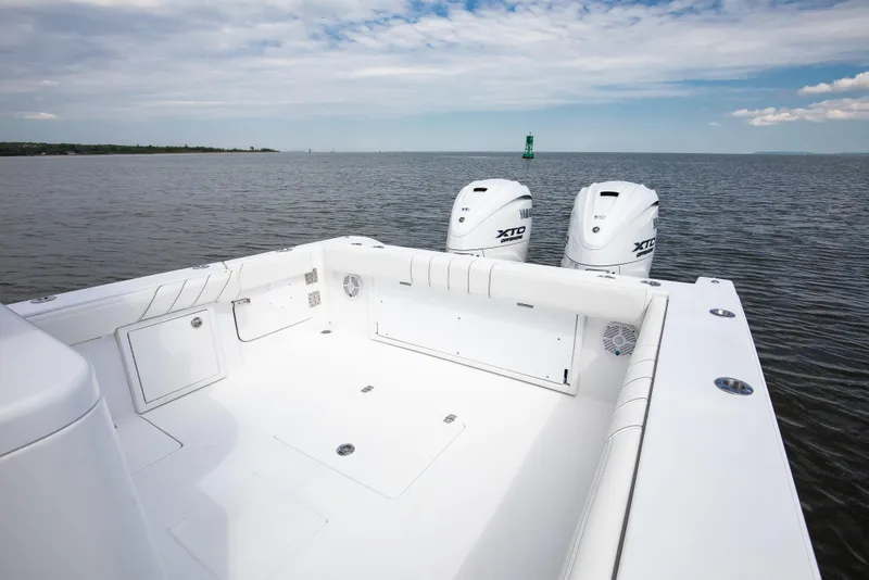 Slide: The Image of 2019 Buddy Davis 34 Center Console boat with twin outboard engines on open water. - 6