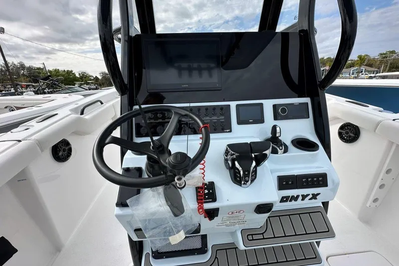 Slide: The Image of 2026 Tidewater 272 LXF boat dashboard with steering wheel and control panel. - 14