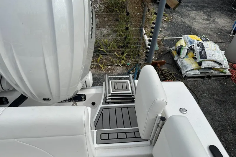 Slide: The Image of 2026 Tidewater 272 LXF boat deck with seating and engine, outdoor setting. - 15