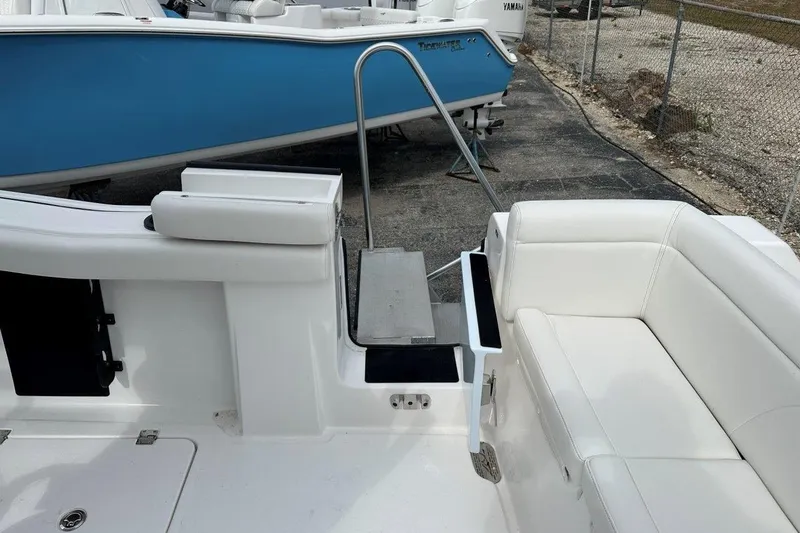 Slide: The Image of 2026 Tidewater 272 LXF boat interior with white seating and swim platform. - 16