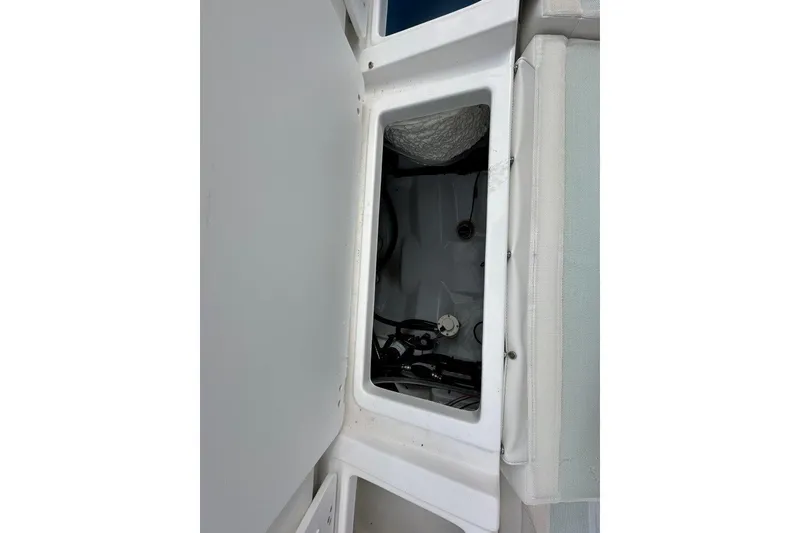 Slide: The Image of Open storage compartment on 2026 Tidewater 272 LXF boat, showcasing interior details. - 18
