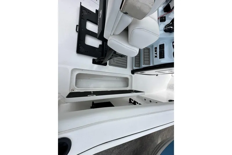 Slide: The Image of 2026 Tidewater 272 LXF boat interior with white seating and storage compartments. - 19