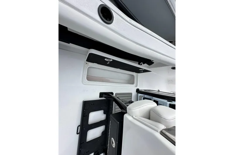 Slide: The Image of Interior view of 2026 Tidewater 272 LXF boat, featuring sleek white seating and storage compartments. - 20