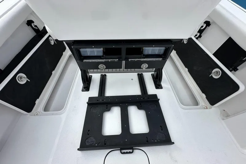 Slide: The Image of 2026 Tidewater 272 LXF boat interior with storage compartments and seating area. - 22
