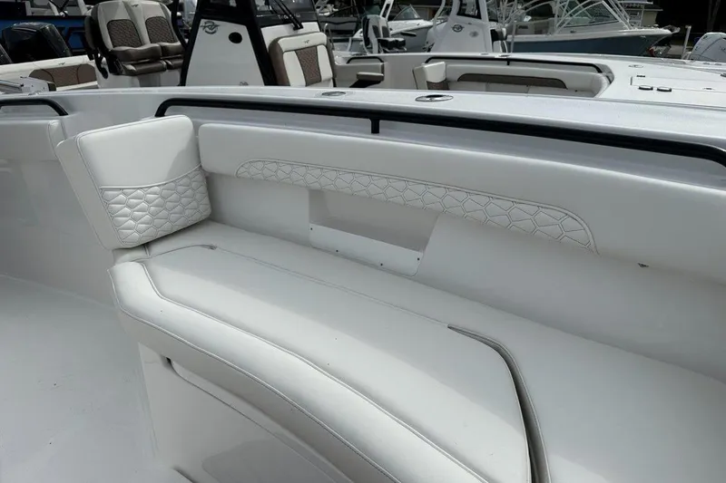 Slide: The Image of 2026 Tidewater 272 LXF boat interior with white cushioned seating and elegant design. - 23