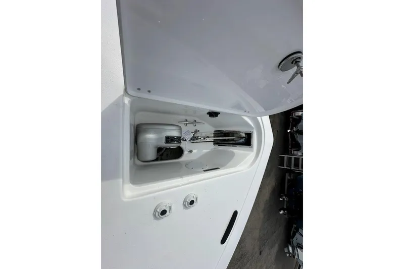 Slide: The Image of 2026 Tidewater 272 LXF boat anchor compartment with open hatch, showcasing storage features. - 24