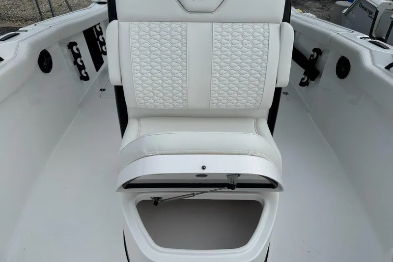 Slide: The Image of 2026 Tidewater 272 LXF boat interior with white cushioned seating and storage compartment. - 26