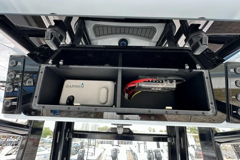 Slide: The Image of 2026 Tidewater 272 LXF boat console with Garmin electronics and storage compartments. - 33
