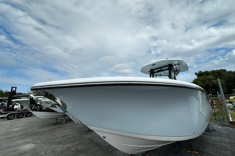 Slide: The Image of 2026 Tidewater 272 LXF boat with sleek design under cloudy sky. - 5