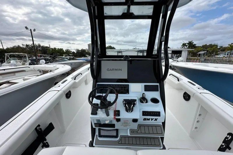 Slide: The Image of 2026 Tidewater 272 LXF boat cockpit with Garmin navigation system, sleek design, and modern controls. - 7