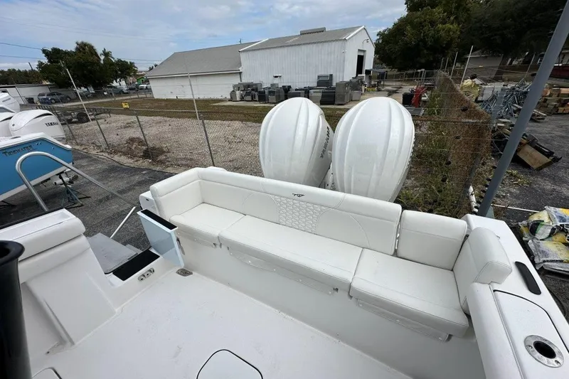 Slide: The Image of 2026 Tidewater 272 LXF boat with white seating and dual outboard engines. - 8