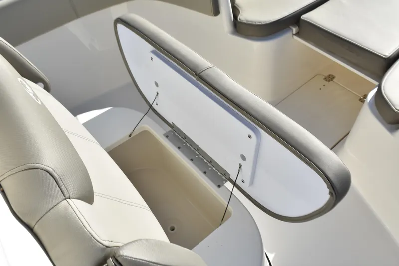 Slide: The Image of 2024 Key West 263 FS boat interior with open storage compartment and cushioned seating. - 12