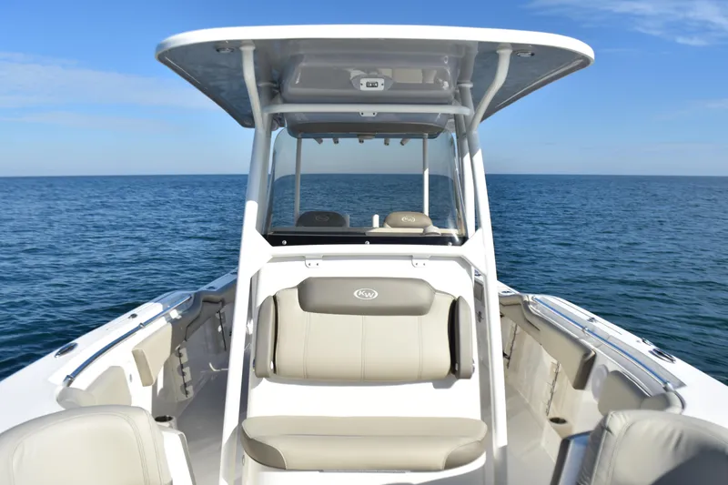 Slide: The Image of 2024 Key West 263 FS boat on open sea, showcasing sleek design and spacious seating. - 13