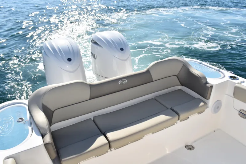 Slide: The Image of 2024 Key West 263 FS boat with dual engines and cushioned seating on open water. - 24