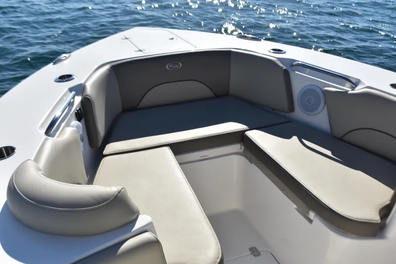 Slide: The Image of 2024 Key West 263 FS boat interior with cushioned seating, on calm water. - 7