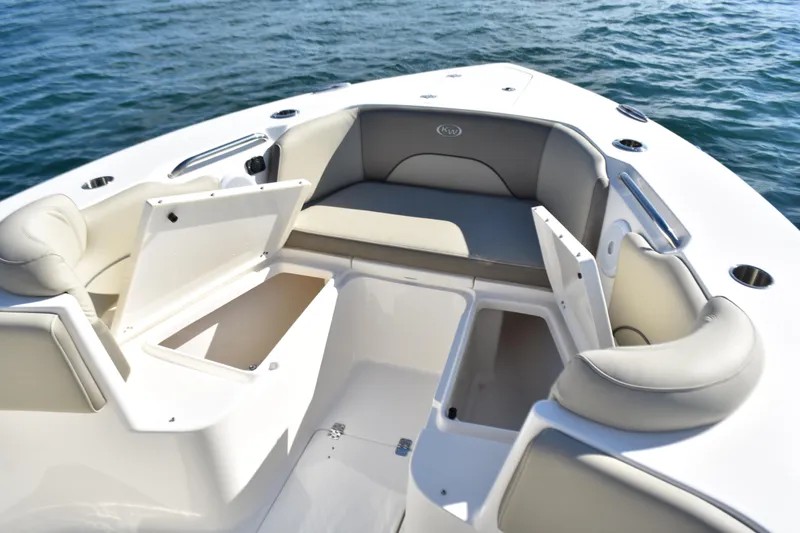 Slide: The Image of 2024 Key West 263 FS boat interior with open storage compartments and cushioned seating. - 8