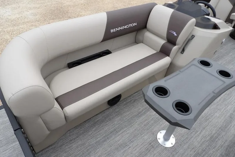 Slide: The Image of 2026 Bennington S Swingback 21 SSB boat interior with plush seating and cup holder table. - 13
