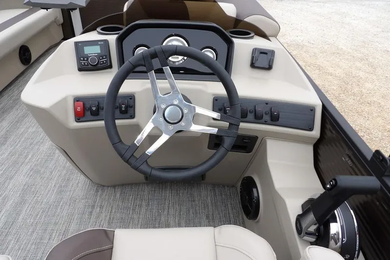 Slide: The Image of 2026 Bennington S Swingback 21 SSB boat dashboard with steering wheel and controls. - 17