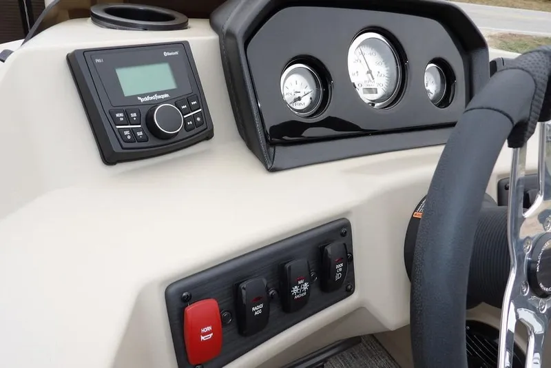 Slide: The Image of 2026 Bennington S Swingback 21 SSB dashboard with controls and steering wheel. - 19