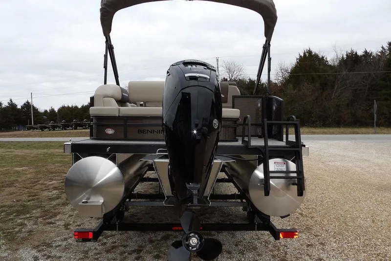 Slide: The Image of 2026 Bennington S Swingback 21 SSB pontoon boat with outboard motor, rear view. - 2