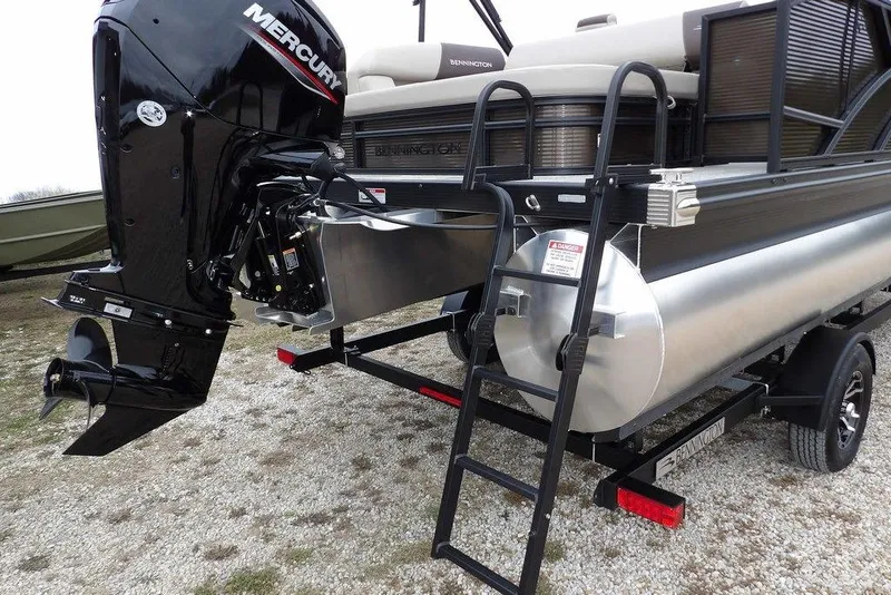 Slide: The Image of 2026 Bennington S Swingback 21 SSB pontoon boat with Mercury outboard engine and trailer. - 31