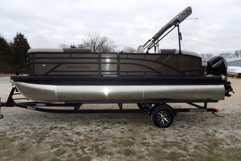 Slide: The Image of 2026 Bennington S Swingback 21 SSB pontoon boat on trailer, side view. - 5