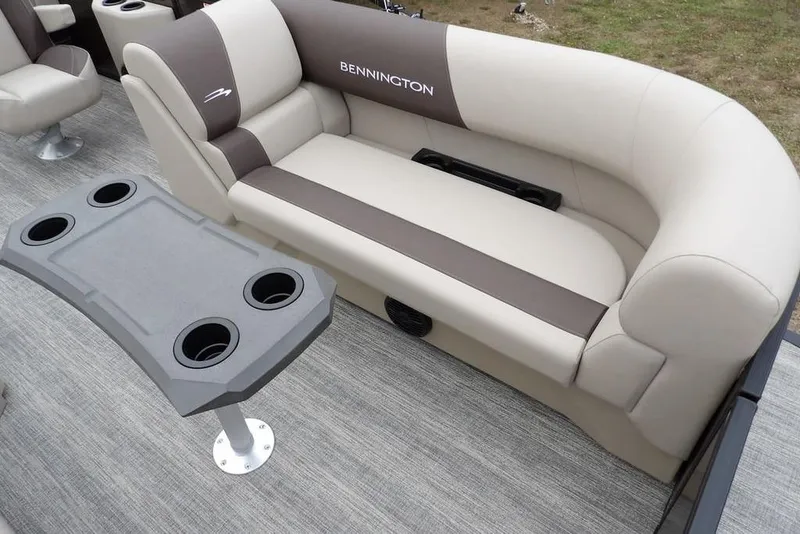 Slide: The Image of 2026 Bennington S Swingback 21 SSB boat interior with seating and cupholder table. - 9