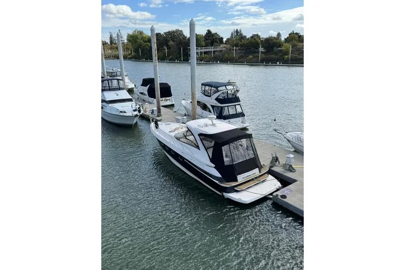 Slide: The Image of 2006 Regal Commodore 4460 yacht docked at a marina with other boats. - 10