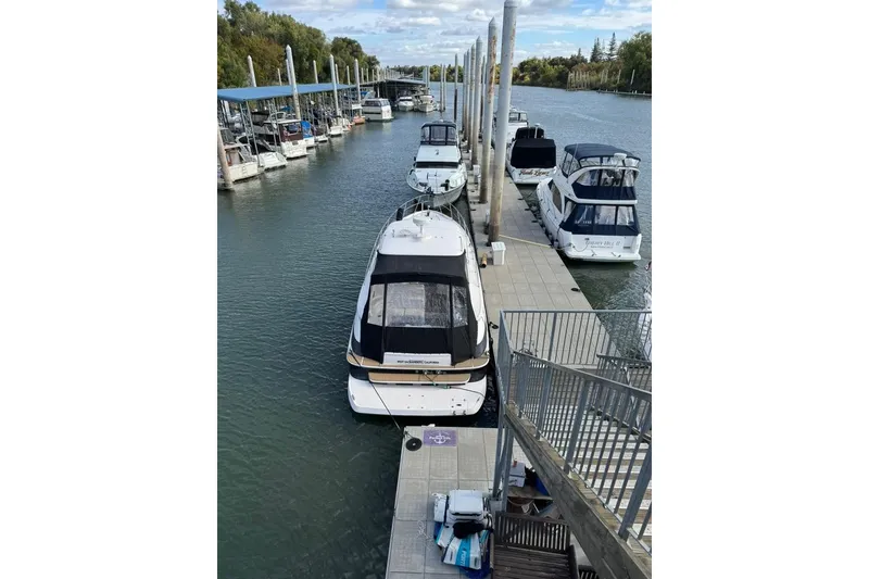 Slide: The Image of 2006 Regal Commodore 4460 yacht docked at marina with other boats. - 12