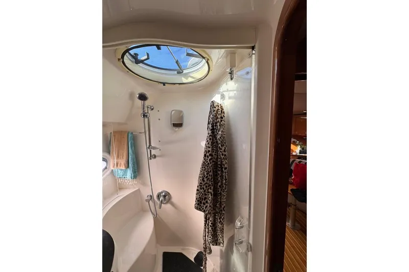 Slide: The Image of Bathroom interior of 2006 Regal Commodore 4460 yacht with shower and porthole. - 15