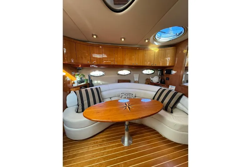Slide: The Image of Luxurious interior of 2006 Regal Commodore 4460 yacht with elegant seating and wooden table. - 23
