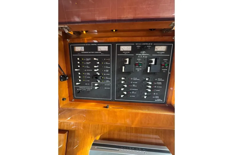 Slide: The Image of Control panel of 2006 Regal Commodore 4460 boat, featuring various switches and gauges. - 24