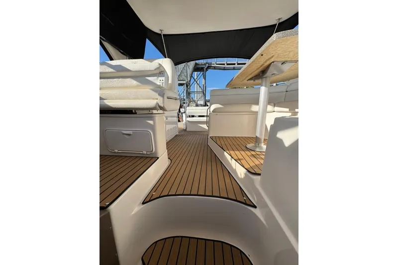 Slide: The Image of 2006 Regal Commodore 4460 yacht interior with wooden flooring and seating area. - 27