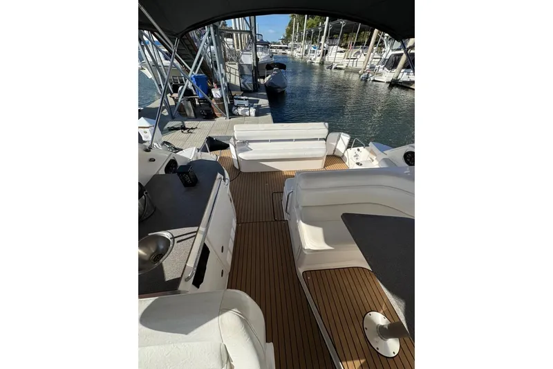 Slide: The Image of 2006 Regal Commodore 4460 yacht interior with seating and marina view. - 30