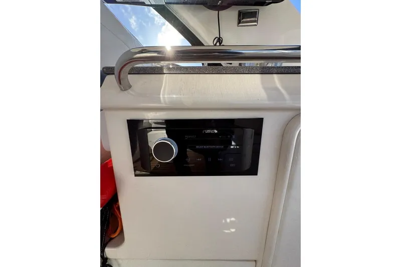 Slide: The Image of Control panel on 2006 Regal Commodore 4460 boat, featuring a Fusion audio system. - 33