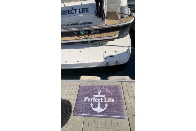 Slide: The Image of 2006 Regal Commodore 4460 yacht named "Perfect Life" docked with welcome mat. - 34