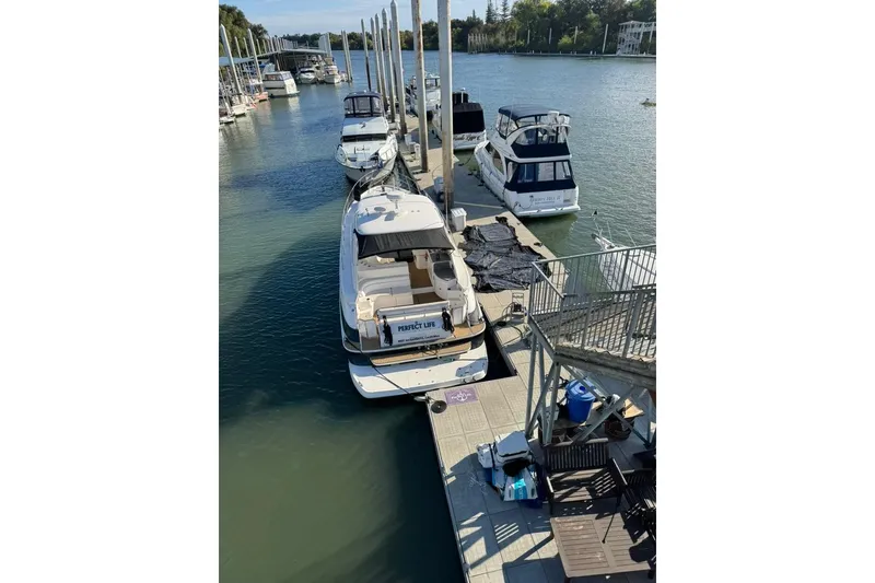 Slide: The Image of 2006 Regal Commodore 4460 yacht docked at marina, surrounded by other boats. - 38