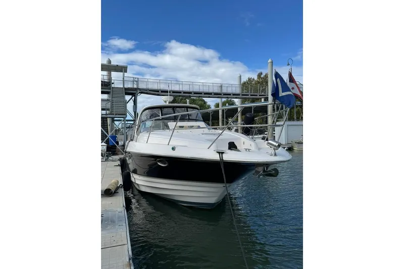 Slide: The Image of 2006 Regal Commodore 4460 yacht docked at marina under blue sky. - 7