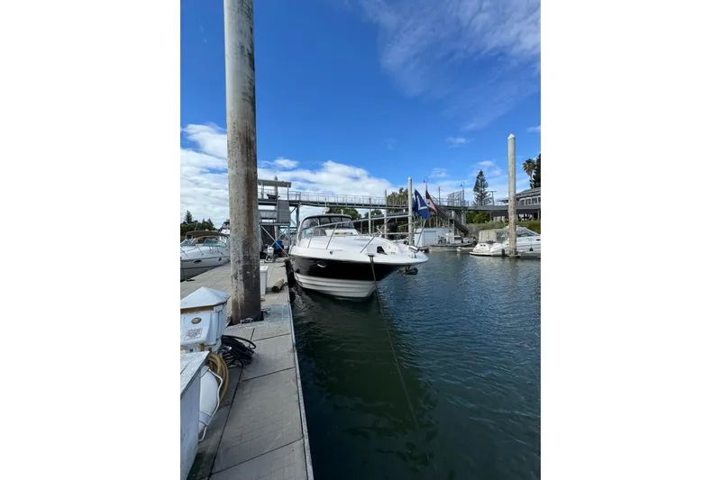 Slide: The Image of 2006 Regal Commodore 4460 yacht docked at marina under blue sky. - 9