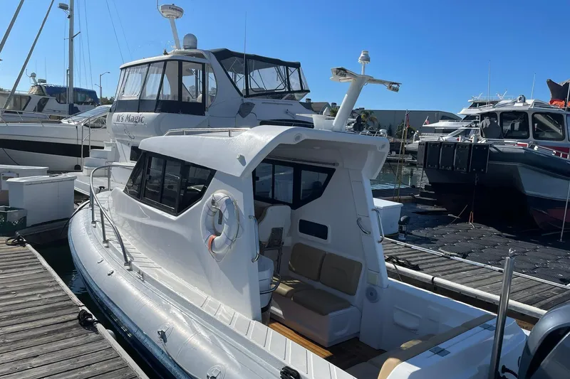 Slide: The Image of 2023 Flexboat Flex 680 Explorer docked at marina, showcasing sleek design and modern features. - 10