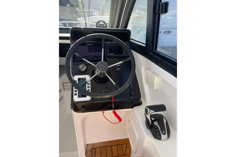 Slide: The Image of 2023 Flexboat Flex 680 Explorer helm with steering wheel and control panel. - 3