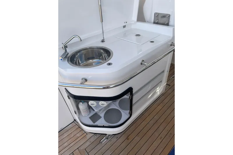 Slide: The Image of 2023 Flexboat Flex 680 Explorer boat sink and storage on wooden deck. - 4