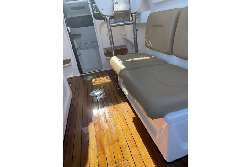 Slide: The Image of 2023 Flexboat Flex 680 Explorer interior with wooden flooring and cushioned seating. - 7