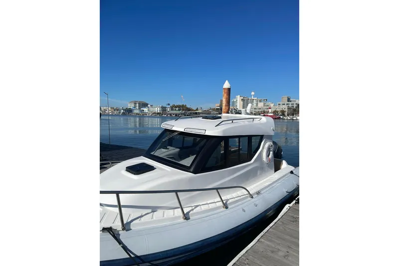 Slide: The Image of 2023 Flexboat Flex 680 Explorer docked at a marina under clear blue skies. - 9